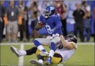  ?? BILL KOSTROUN — THE ASSOCIATED PRESS ?? New York Giants quarterbac­k Josh Johnson (8) is sacked by Pittsburgh Steelers linebacker T.J. Watt (90) during the first quarter of a preseason NFL football game, Friday in East Rutherford, N.J.