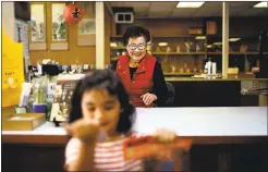  ??  ?? Tee Kogura, the owner ofa Japanese gift shop, Kogura Company, smiles at a young customer, Nawal Haidar, 4, in January in San Jose’s Japantown.