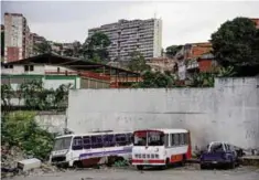  ??  ?? CARACAS: This photo taken on Oct 13, 2016 shows abandoned buses in a public bus parking in the Catia neighborho­od of the Venezuelan capital. —AFP