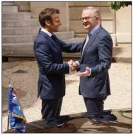 ?? (AP/ Thomas Padilla) ?? French President Emmanuel Macron (left) welcomes Australian Prime Minister Anthony Albanese to the French presidenti­al palace Friday in Paris.