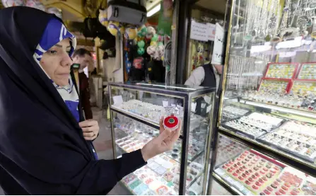  ?? ?? A customer shows a stone ring in a shop at the old bazaar in the city of Shahr-e Ray (Rey), south of Tehran, Iran.