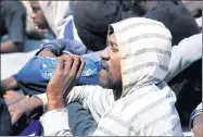  ?? ISMAIL ZITOUNY / REUTERS ?? A migrant drinks water after he and others were rescued by the Libyan Coast Guard, at a naval post near Tripoli, Libya, on Tuesday.