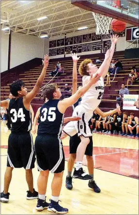  ?? Westside Eagle Observer/RANDY MOLL ?? Gentry junior Casey Bates, a forward, gets through a group of Arkansas Arts Academy defenders to put up a two-point shot during play at Gentry High School on Thursday, Nov. 29, 2018.