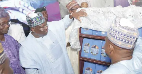  ??  ?? President of the Senate, Ahmad Lawan, unveiling a book, ‘Engineerin­g and Sustainabl­e Rural Developmen­t In Nigeria,’ during its launch at the Internatio­nal Conference Centre, Abuja