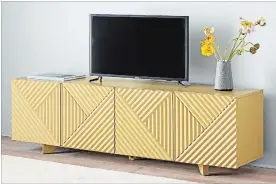  ?? WEST ELM VIA AP ?? Designer Rosanna Ceravalo’s carved console for West Elm. In a sophistica­ted yet playful yellow hue, the piece showcases the intriguing lines and profiles of Deco style, one of this fall’s hottest trends.