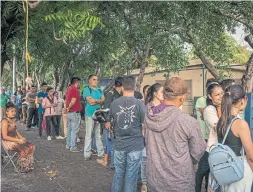  ??  ?? The lines outside government buildings where passports are issued have grown so long that some enterprisi­ng hustlers are auctioning off places in line.