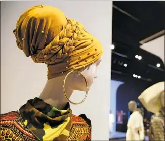  ?? Eric Risberg Associated Press ?? THIS HEADSCARF and wrap are displayed in the exhibition “Contempora­ry Muslim Fashions.”