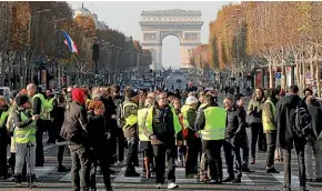  ?? AP ?? Protesters block the Champs Elysees avenue to protest fuel taxes in Paris, France.