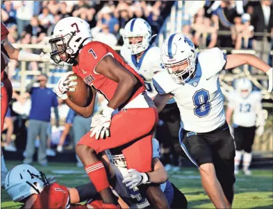  ?? Michelle Petteys, Heritage Snapshots ?? Heritage receiver Sam Randolph tries to get through traffic while Ringgold’s Brandon Orman (9) and Mason Parker (8) look to make the stop. Randolph had 73 yards and two touchdowns receiving, while also adding the go-ahead score on a 99-yard kickoff return, in the Generals’ 27-14 victory over the Tigers at Jeff Sims Field.