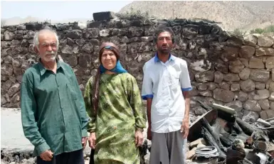  ?? (Courtesy) ?? A BAHA’I FAMILY in Fars province stands near where an arson attack was committed.