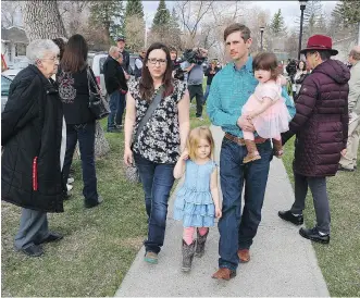  ?? AL CHAREST ?? Eddie Maurice and his family make their way into the Okotoks Provincial Court building on Friday. The local landowner is facing charges of aggravated assault, pointing a firearm and careless use of a firearm, following a robbery at his home in...