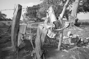  ??  ?? Clothing are pictured on a wire fence at the site of unmarked graves where a forensic team and judicial authoritie­s are working in after human skulls were found, in Alvarado,Veracruz state, Mexico. — Reuters photo