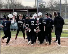  ?? Graham Thomas/Siloam Sunday ?? Siloam Springs senior JP Wills (No. 7) approaches his teammates at home plate after hitting a home run in the Panthers’ 10-6 win against Rogers Heritage on Thursday at James Butts Baseball Park.