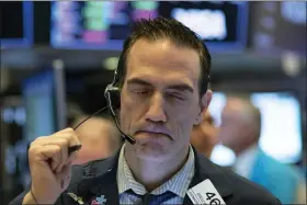  ?? MARK LENNIHAN — THE ASSOCIATED PRESS ?? Stock trader Gregory Rowe works at the New York Stock Exchange on Wednesday in New York.