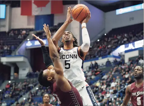  ?? Jessica Hill / Associated Press ?? UConn’s Isaiah Whaley, right, shoots over Maryland-Eastern Shore’s Donchevell Nugent in the first half of Tuesday’s game in Hartford.