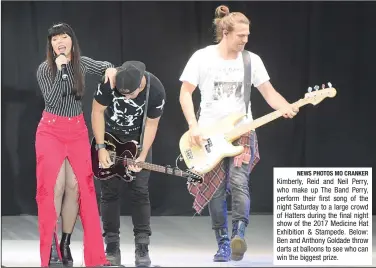  ?? NEWS PHOTOS MO CRANKER ?? Kimberly, Reid and Neil Perry, who make up The Band Perry, perform their first song of the night Saturday to a large crowd of Hatters during the final night show of the 2017 Medicine Hat Exhibition &amp; Stampede. Below: Ben and Anthony Goldade throw darts at balloons to see who can win the biggest prize.