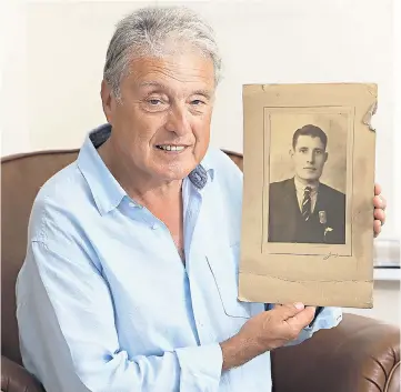  ??  ?? Stan Gibson with a picture of his late father Wilfred, who was taken into care