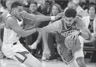  ?? STRAZZANTE/SAN FRANCISCO CHRONICLE/AP PHOTO ?? Boston Celtics forward Jayson Tatum drives toward the basket as Golden State Warriors guard Jordan Poole defends during the fourth quarter in Game 1 of the NBA Finals on Thursday in San Francisco.