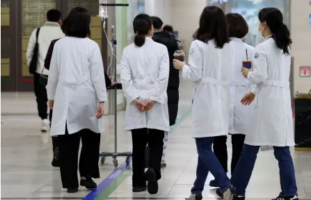  ?? — AFP photo ?? Medical staff are seen at a university hospital in Gwangju. Hundreds of trainee doctors handed in their resignatio­ns Monday and were set to stop work from Tuesday.
