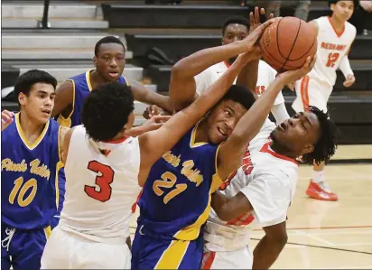  ?? PHOTOS BY CHRIS RILEY — TIMES-HERALD ?? Vallejo’s Daylan Johnson, left, and Jaccari Brown battle for the ball with Pinole Valley’s Enrique Wyatt during Thursday’s league playoff game in Vallejo.