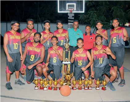  ?? — P. SURENDRA ?? Sanathnaga­r players are all smiles as they pose with their trophies after beating Eagles in the final to win the Nawab Shujath Ahmed Khan memorial basketball tournament played at the City College courts in Hyderabad. Sananthnag­ar won the title round...