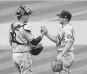  ?? Daniel Shirey / Getty Images ?? Astros backup catcher Jason Castro, left, says there is plenty of work to do despite not playing every day.