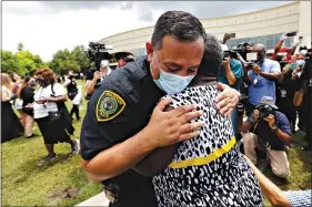  ?? AP Photo/Eric Gay ?? Houston police chief Art Acevedo and Charlene Davis embrace after Davis prayed for him as she stood in line at a public visitation for George Floyd at The Fountain of Praise church Monday in Houston.