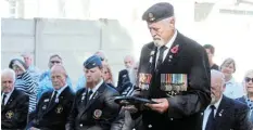  ?? ?? OLD BILL: Kevin Riddin lays a wreath on behalf of the Moths.