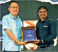  ?? ?? Deputy head of mission for Chinese Embassy, Counsellor Wang Xuguang handing over a special gift to Post Fiji’s chief executive officer, Anirudha Bansod during Post Fiji 150th year celebratio­n at Vodafone Arena on December 18, 2021.