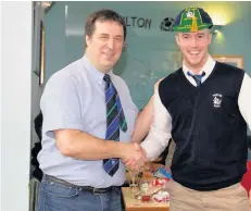  ??  ?? Cap fits Hamilton star Ross Inglis was given a cap to mark his 100th first-team appearance, from vice-president Ross Whiteside