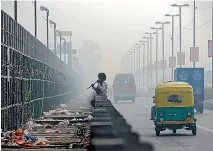  ?? PHOTO: REUTERS ?? A man chews sugarcane on a bridge during a smoggy morning in New Delhi, India.