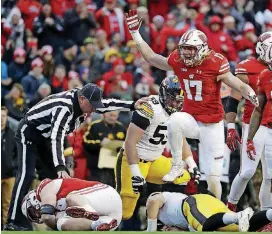  ?? [PHOTO BY THE ASSOCIATED PRESS] ?? Wisconsin’s Andrew Van Ginkel celebrates a Badger sack of Iowa quarterbac­k Nathan Stanley last week.