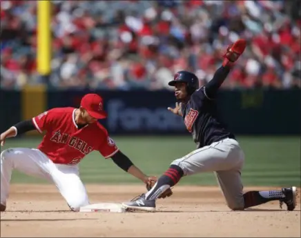  ?? JAE C. HONG — THE ASSOCIATED PRESS ?? The Indians’ Francisco Lindor gestures after stealing second as the Angels’ Andrelton Simmons tries to apply the tag in the fifth inning.