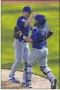  ?? MORRY GASH - AP ?? Chicago Cubs starting pitcher Alec Mills is congratula­ted by catcher Victor Caratini after throwing a no hitter against the Milwaukee Brewers Sunday in Milwaukee. The Cubs won 12-0.