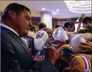  ?? BUTCH DILL — ASSOCIATED PRESS ?? LSU coach Ed Orgeron signs autographs during the SEC’s annual media gathering, July 10 in Hoover, Ala.