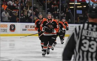  ?? NEWS PHOTO JAMES TUBB ?? Medicine Hat Tigers forward Gavin McKenna leads the train of players to the bench after scoring an early first period goal in a 3-1 Game 2 win March 30 over the Red Deer Rebels in their first-round series.