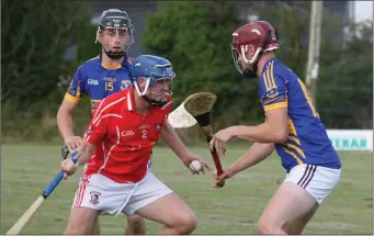  ??  ?? Fethard defender Seán Sutton is bottled up by Gusserane duo Kevin O’Donohoe and Mark O’Neill in the local derby clash in the Greenstar Under-21 hurling Premier championsh­ip in Tom Somers Park.