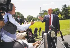  ?? Alex Brandon / Associated Press ?? President Donald Trump has an exchange with NBC News White House correspond­ent Peter Alexander, left, while speaking with reporters before departing on Marine One on the South Lawn of the White House in Washington on Wednesday. Trump is headed to Kentucky.