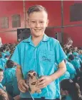  ??  ?? AWARD: Jack Tubb receives Mrs Kearney's NZ owl.