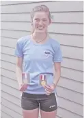  ?? COURTESY PHOTO ?? Superstar sophomore runner Julia Wood poses with her two state championsh­ip medals — her third and fourth overall.