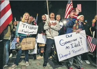  ?? Robert Gauthier Los Angeles Times ?? PROTESTERS in Huntington Beach criticize one of their favorite targets, Gov. Gavin Newsom, and celebrate President Trump — two weeks after his election defeat he has yet to acknowledg­e.