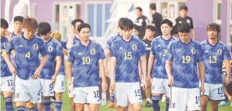  ?? — AFP photo ?? (From left) Japan’s defender Kou Itakura, Japan’s midfielder Takumi Minamino, Japan’s midfielder Daichi Kamada, Japan’s defender Hiroki Sakai arrive for a training session at the Al Sadd SC training grounds in Doha.
