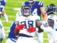  ?? AP PHOTO/ DARRON CUMMINGS ?? Tennessee Titans defensive end Jeffery Simmons (98) celebrates a defensive stop with free safety Desmond King (33) in the second half of their game Sunday against the Indianapol­is Colts in Indianapol­is.