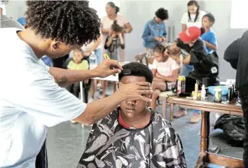  ?? Picture: MARK ANDREWS ?? FRESH FADES: Guardians of Agape Love provided more than 700 local children with free hairstyles over the past week.