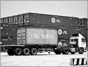  ?? CHINATOPIX ?? A truck moves a shipping container at a port in China, which has criticized the latest U.S. threat of a tariff hike.