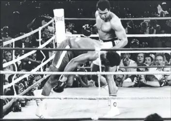  ?? THE ASSOCIATED PRESS FILE PHOTO ?? Muhammad Ali watches George Foreman head for the canvas after being knocked out in the eighth round of their heavyweigh­t title match in Kinshasa, Zaire, on Oct. 30, 1974. Ali, the magnificen­t heavyweigh­t champion whose fast fists and irrepressi­ble...
