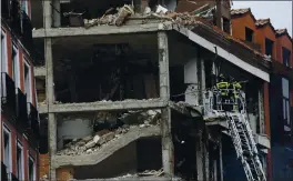  ?? ANDREA COMAS — THE ASSOCIATED PRESS ?? Firefighte­rs work on a damaged building at Toledo Street following an explosion in Madrid, Spain, Wednesday.