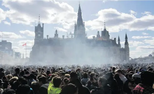  ?? LARS HAGBERG / AFP / GETTY IMAGES FILES ?? Smoke rises at the annual 4/20 rally on Parliament Hill in Ottawa on April 20. Small business has concerns over legalizati­on, ranging from workplace safety to provincial trade barriers and red tape.