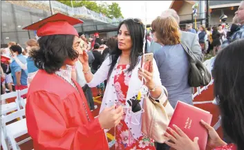  ?? Christian Abraham / Hearst Connecticu­t Media file photo ?? Derby High School's graduation ceremony at Payden Park in Derby on June 11, 2019.