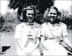  ?? PHOTOS COURTESY OF VIRGINIA COWART ?? Virginia Cowart and her sister sit together during World War II in Hawaii with their gas masks just outside the frame.